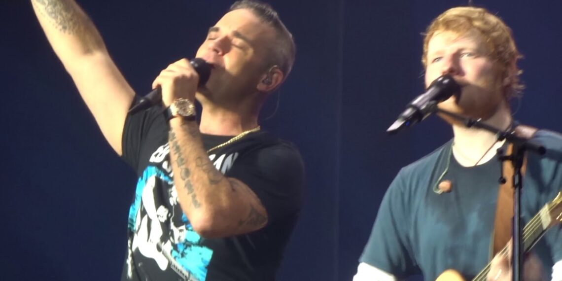 Ed Sheeran Brings Out Robbie Williams for Surprise ‘Angels’ Duet in Amsterdam – A Stadium of Goosebumps as Two British Icons Unite for That Robbie Classic… and the Crowd? LOUD!