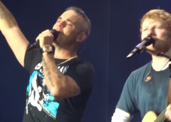 Ed Sheeran Brings Out Robbie Williams for Surprise ‘Angels’ Duet in Amsterdam – A Stadium of Goosebumps as Two British Icons Unite for That Robbie Classic… and the Crowd? LOUD!