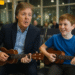 Paul McCartney was spotted sitting quietly when a young boy began strumming “Yesterday” on his ukulele. To the astonishment of fellow travelers, Paul politely asked to borrow the instrument and joined in for an impromptu duet. The spontaneous performance turned the bustling terminal into an intimate concert hall, with onlookers pulling out their phones to capture the magic. Eyewitnesses describe the scene as heartwarming, with smiles, applause, and a few happy tears all around. Sources reveal that Paul chatted with the boy afterward, praising his talent and encouraging him to keep playing. Social media quickly exploded with videos of the heart-melting encounter, spreading joy worldwide. By the end, the airport was buzzing not just with travelers, but with the unforgettable thrill of witnessing a Beatle live, up close, and unplanned.