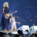 Even on a projection some 20 years after his death, Brian May’s guitar can still control and whip up an entire audience of 50,000+ people, which very few deceased musicians can do. Each riff cuts through the air with the precision of a living, breathing performer, and the stadium pulses as if Brian himself were striding across the stage. Fans wave, cheer, and sway, caught in a spell where time seems to fold, merging past and present in one electrifying moment. In that instant, it’s not just a hologram—it’s a resurrection, a reminder that true legends never fade, and their music continues to breathe life into every heart it touches